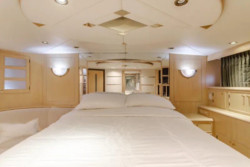Artemis Yacht Photos Pics Luxurious bedroom interior of a 1996 Offshore Yachts Pilothouse, featuring elegant wood finishes.