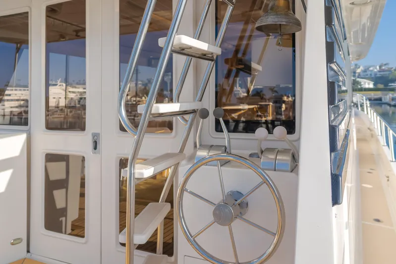 Artemis Yacht Photos Pics 1996 Offshore Yachts Pilothouse with exterior stairs and helm wheel.