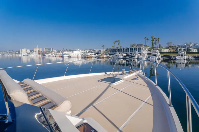 Artemis Yacht Photos Pics 1996 Offshore Yachts Pilothouse on calm waters with marina view.