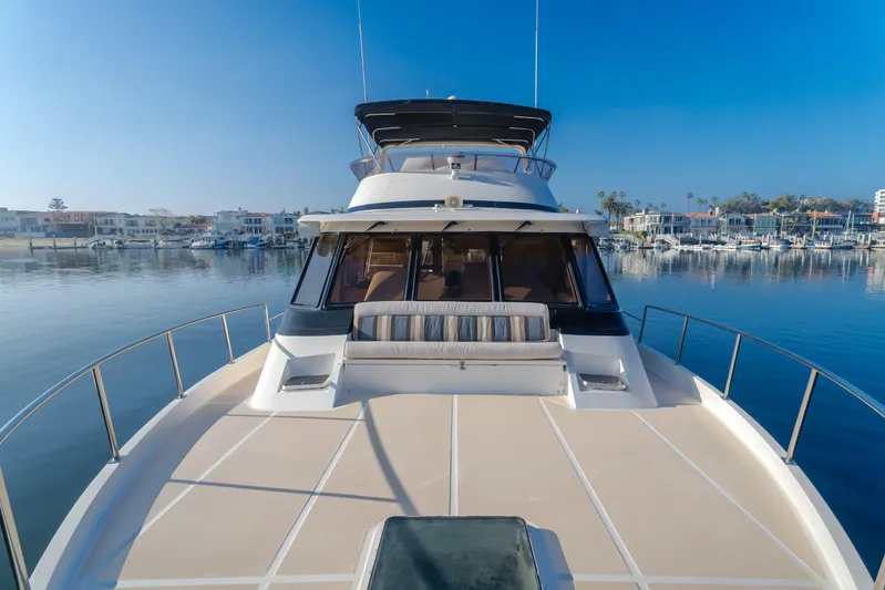 Artemis Yacht Photos Pics 1996 Offshore Yachts Pilothouse on calm water, showcasing spacious deck and sleek design.