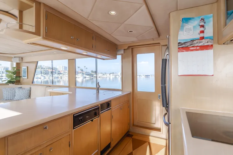 Artemis Yacht Photos Pics Interior of 1996 Offshore Yachts Pilothouse with kitchen and scenic window view.
