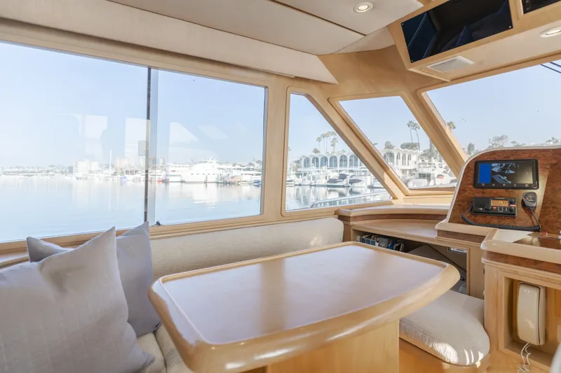 Artemis Yacht Photos Pics Interior of 1996 Offshore Yachts Pilothouse with scenic marina view through large windows.