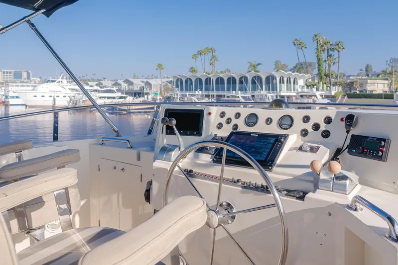 Artemis Yacht Photos Pics 1996 Offshore Yachts Pilothouse helm with marina view, featuring modern navigation equipment.