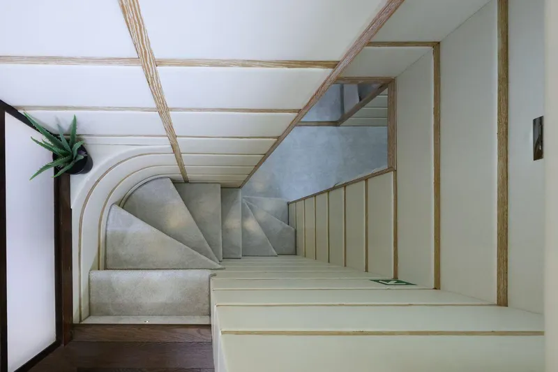 Dea One Yacht Photos Pics Modern staircase with minimalist design, featuring light wood accents and a potted plant.