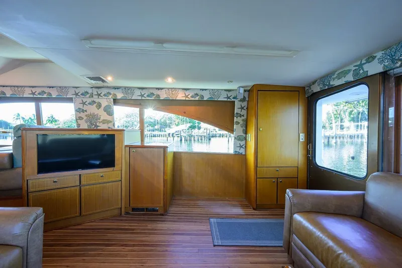 Hook'em Dan O Yacht Photos Pics Luxurious interior of 2006 Ocean Yachts 57 Super Sport with wood finishes and waterfront view.