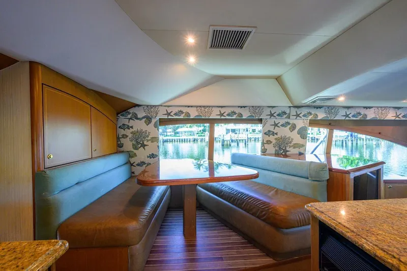 Hook'em Dan O Yacht Photos Pics Luxurious interior of 2006 Ocean Yachts 57 Super Sport with elegant seating and scenic window view.