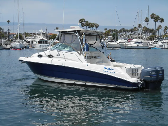 Delfini Yacht Photos Pics 2007 Wellcraft Coastal 270 boat docked in a marina with other boats.