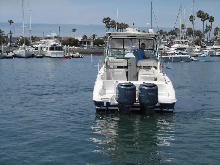 Delfini Yacht Photos Pics 2007 Wellcraft Coastal 270 boat in a marina with twin outboard engines.