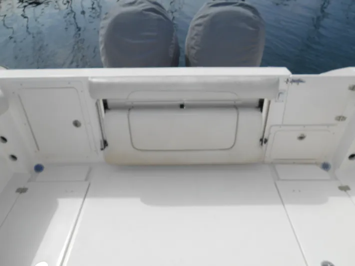 Delfini Yacht Photos Pics 2007 Wellcraft Coastal 270 boat deck with storage compartments and twin engines.