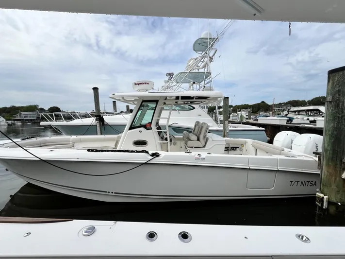 Yacht Photos Pics 2018 Boston Whaler 330 Outrage docked at marina, side view.