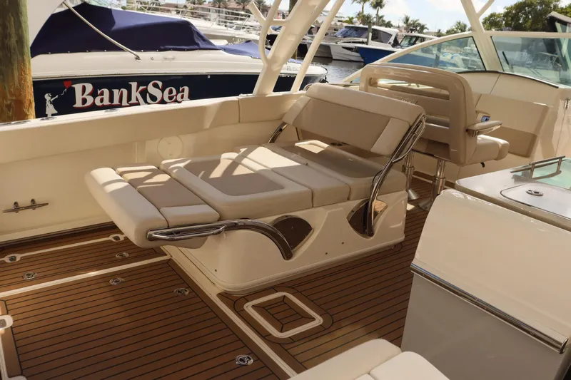  Yacht Photos Pics 2021 Boston Whaler 320 Vantage interior with luxurious seating and teak flooring.