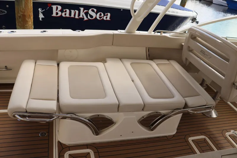  Yacht Photos Pics 2021 Boston Whaler 320 Vantage boat interior with cushioned seating and teak flooring.