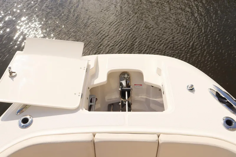  Yacht Photos Pics 2021 Boston Whaler 320 Vantage boat anchor compartment with open hatch, on calm water.