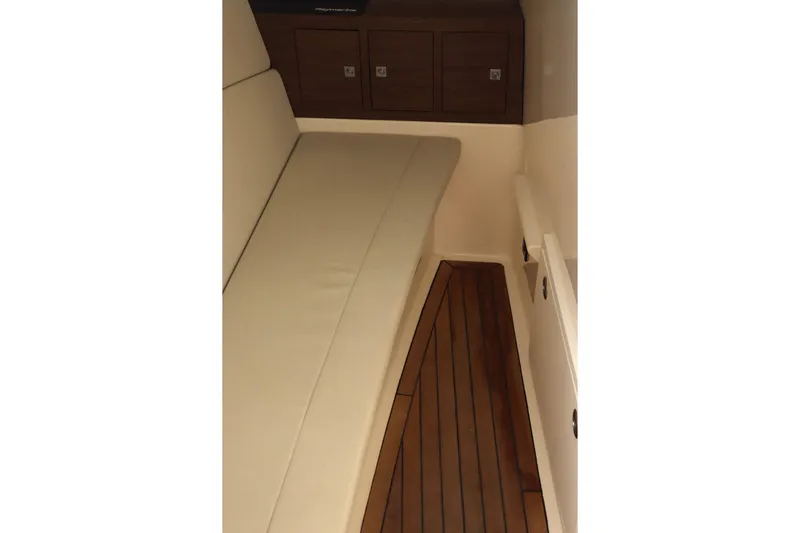  Yacht Photos Pics Interior of 2021 Boston Whaler 320 Vantage with cushioned seating and wooden flooring.