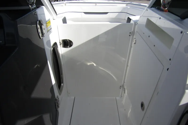  Yacht Photos Pics 2023 Blackfin 252 DC boat interior with open storage compartment.