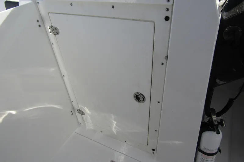  Yacht Photos Pics 2023 Blackfin 252 DC boat storage compartment with secure latch and fire extinguisher.