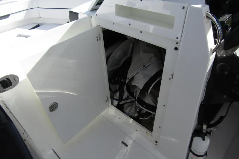  Yacht Photos Pics Open storage compartment on 2023 Blackfin 252 DC boat, showing interior space and equipment.
