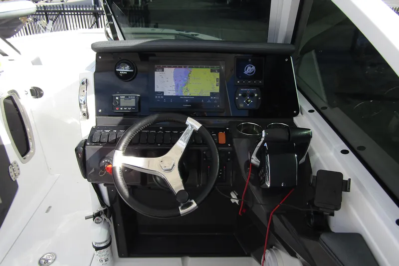  Yacht Photos Pics 2023 Blackfin 252 DC boat dashboard with steering wheel and navigation display.