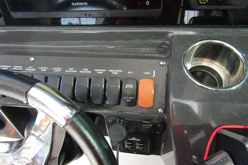  Yacht Photos Pics Control panel of 2023 Blackfin 252 DC boat with steering wheel and switches.
