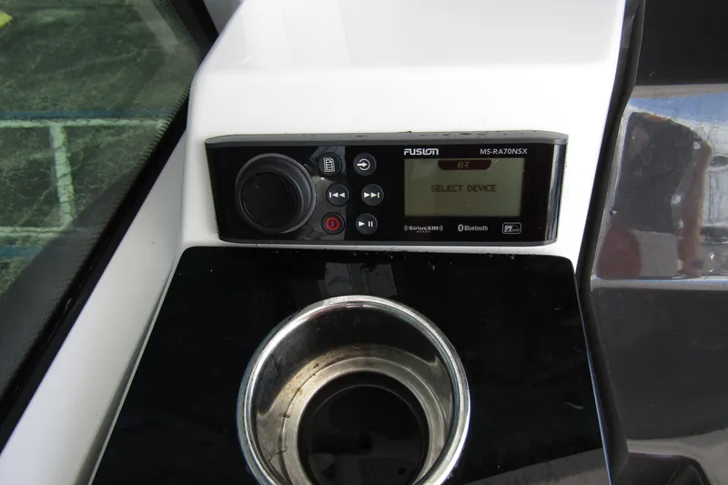 Yacht Photos Pics 2023 Blackfin 252 DC boat console with Fusion MS-RA70NSX audio system and cup holder.