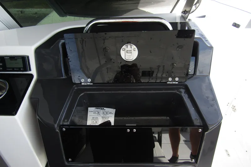  Yacht Photos Pics 2023 Blackfin 252 DC boat dashboard with storage compartment and control panel.