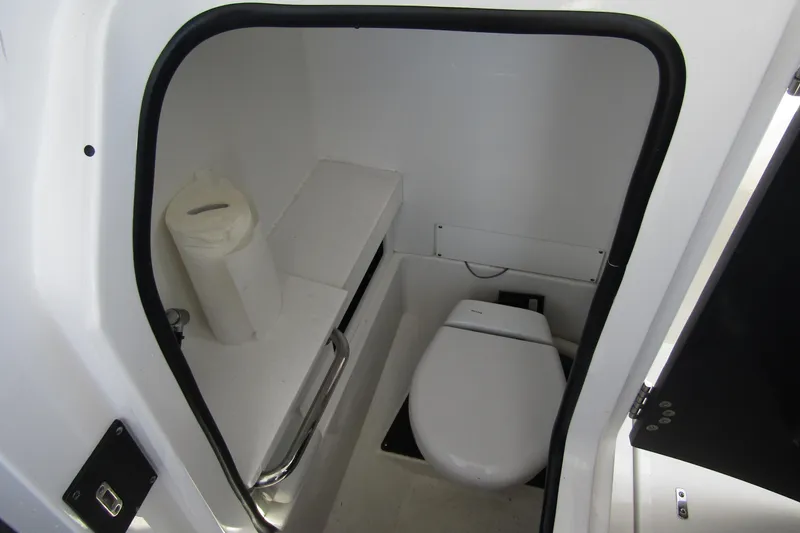  Yacht Photos Pics 2023 Blackfin 252 DC boat interior bathroom with toilet and paper holder.