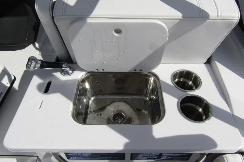  Yacht Photos Pics 2023 Blackfin 252 DC boat sink with faucet and cup holders.