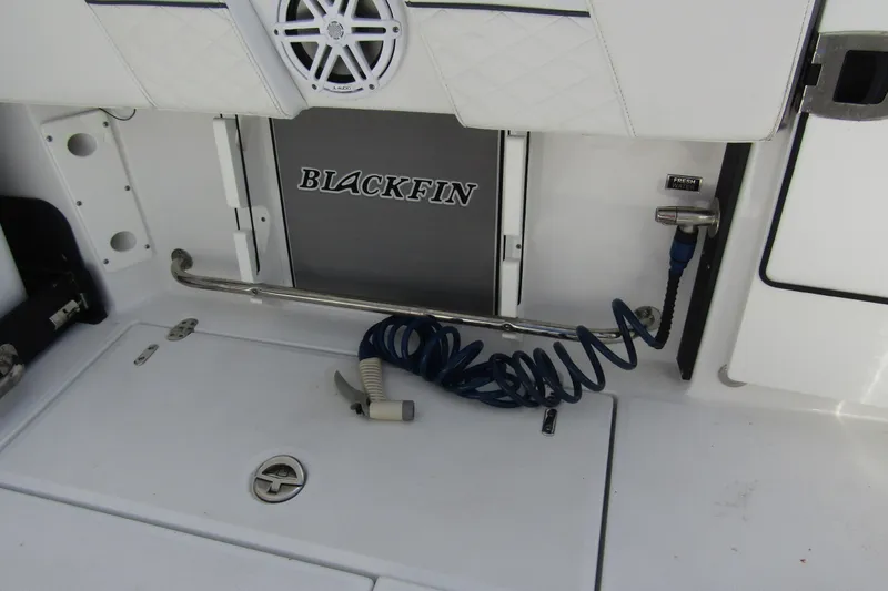  Yacht Photos Pics 2023 Blackfin 252 DC boat deck with coiled hose and storage compartment.