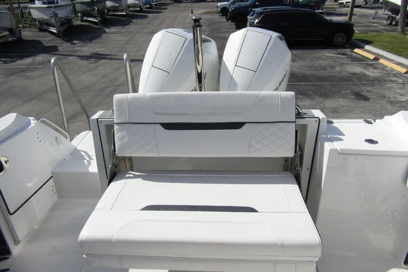  Yacht Photos Pics 2023 Blackfin 252 DC boat with dual outboard engines and white seating.