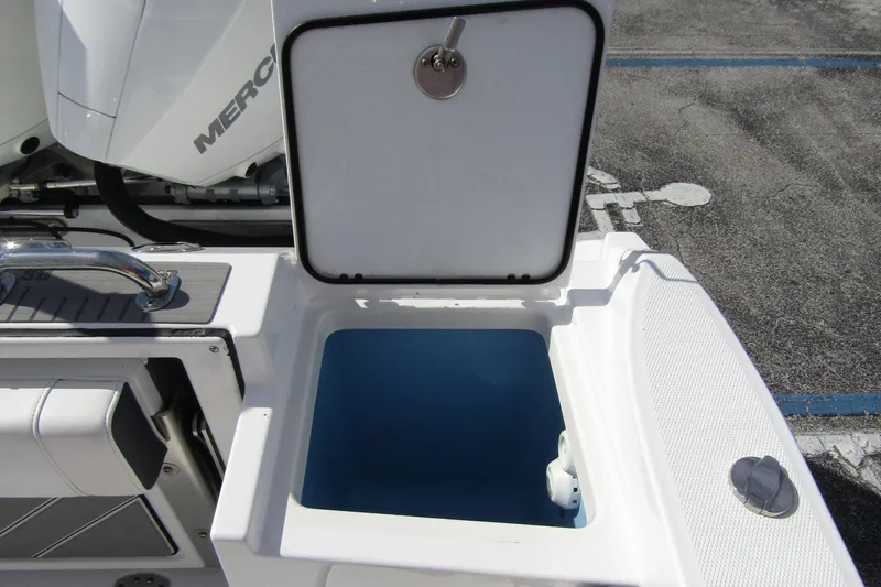  Yacht Photos Pics 2023 Blackfin 252 DC boat with open storage compartment and visible engine.