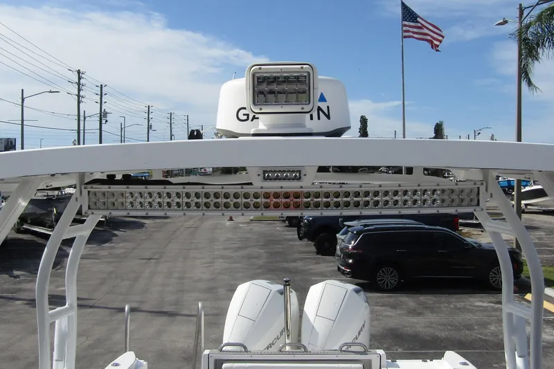  Yacht Photos Pics 2023 Blackfin 252 DC boat with radar and lighting system, parked near American flag.