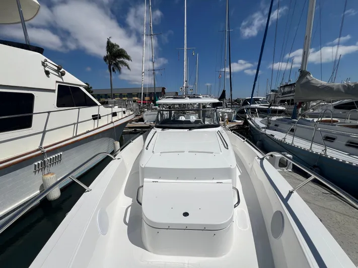 San #292 In Stock Yacht Photos Pics 2024 Nimbus T11 boat docked at marina under clear blue sky.