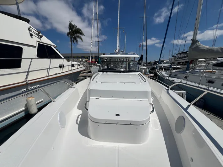 San #292 In Stock Yacht Photos Pics 2024 Nimbus T11 boat docked at marina under clear blue sky.