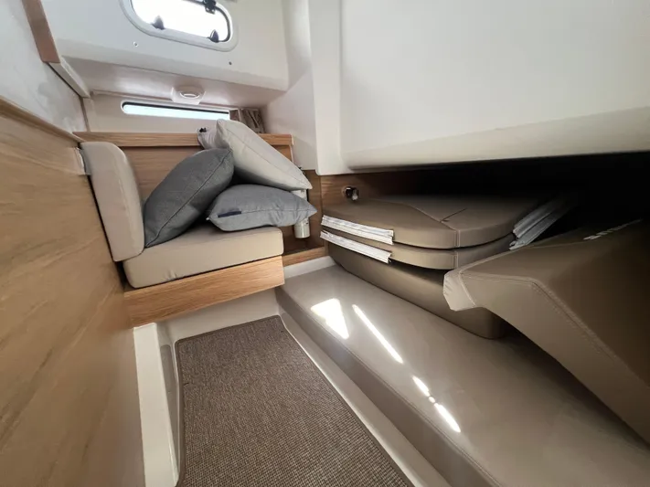 San #292 In Stock Yacht Photos Pics Interior of 2024 Nimbus T11 boat with cushioned seating and modern design.