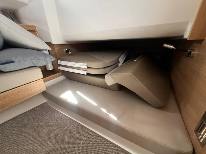 San #292 In Stock Yacht Photos Pics 2024 Nimbus T11 interior storage with cushions and bedding.