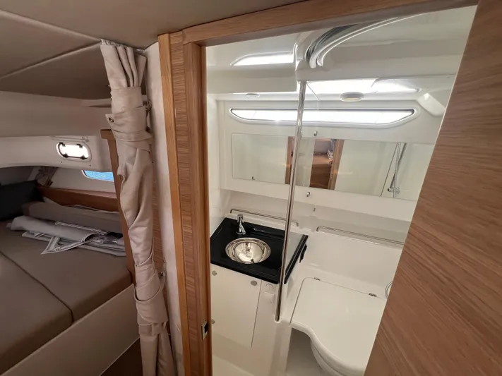 San #292 In Stock Yacht Photos Pics Luxurious 2024 Nimbus T11 yacht interior with modern bathroom and cozy bedroom.