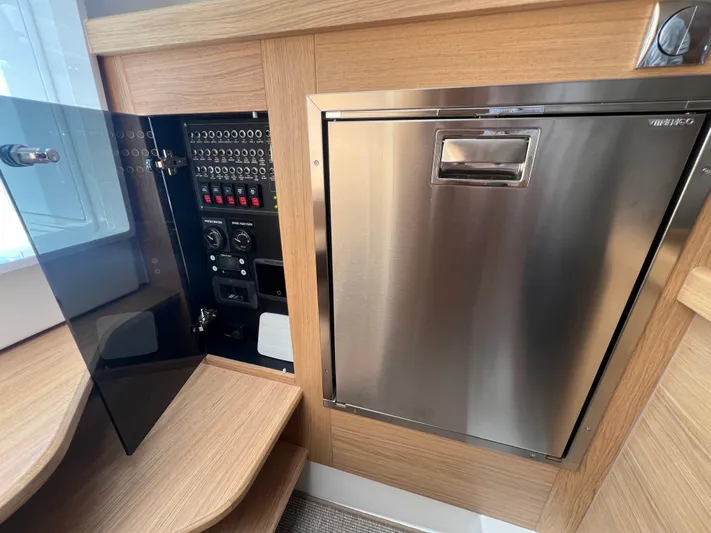 San #292 In Stock Yacht Photos Pics Control panel and stainless steel compartment in 2024 Nimbus T11 boat interior.