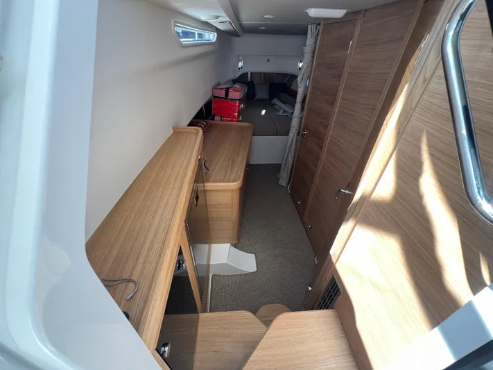 San #292 In Stock Yacht Photos Pics Interior of 2024 Nimbus T11 boat with wooden cabinetry and modern design.