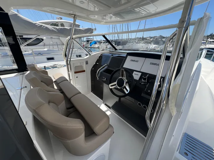 San #292 In Stock Yacht Photos Pics 2024 Nimbus T11 boat cockpit with modern steering and navigation systems.