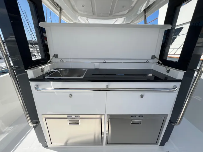 San #292 In Stock Yacht Photos Pics Outdoor kitchen on 2024 Nimbus T11 yacht with sink and storage.