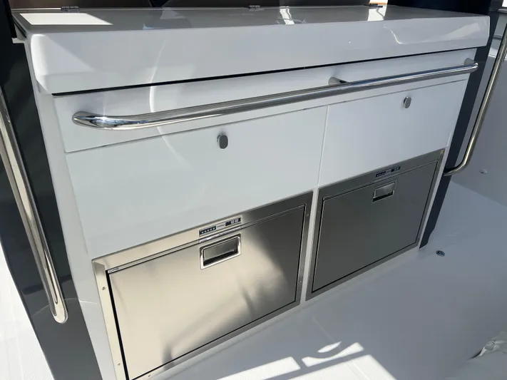 San #292 In Stock Yacht Photos Pics 2024 Nimbus T11 boat kitchen with stainless steel drawers and sleek design.