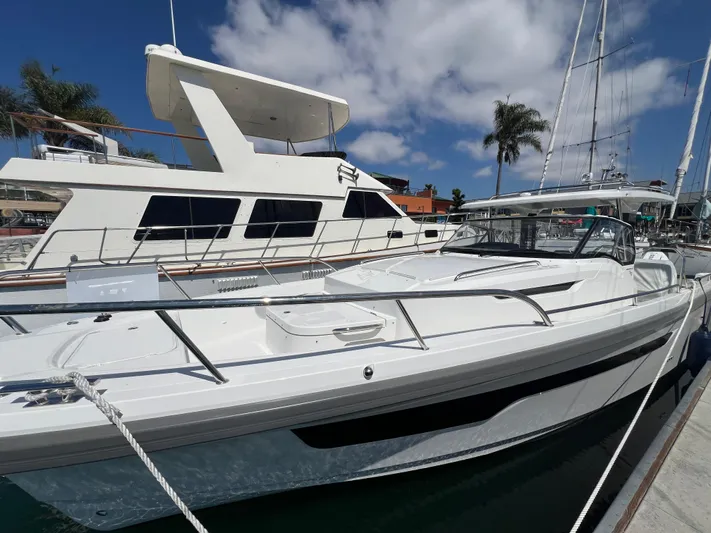 San #292 In Stock Yacht Photos Pics 2024 Nimbus T11 boat docked at marina under clear blue sky.