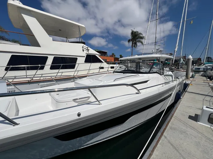 San #292 In Stock Yacht Photos Pics 2024 Nimbus T11 boat docked at marina under blue sky.