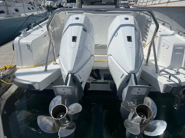 San #292 In Stock Yacht Photos Pics 2024 Nimbus T11 boat with dual outboard engines at a marina.
