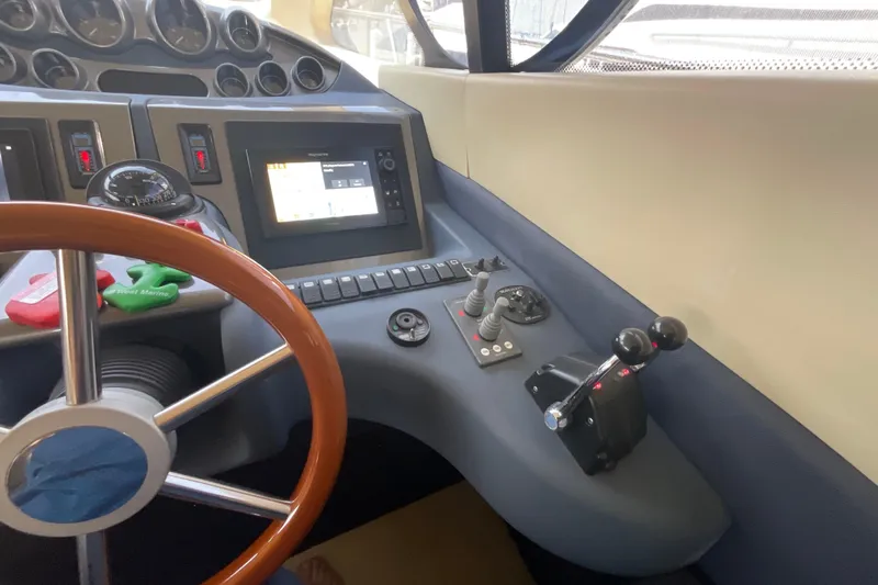  Yacht Photos Pics Control panel of a 2005 Azimut Fly 50 yacht with steering wheel and navigation instruments.