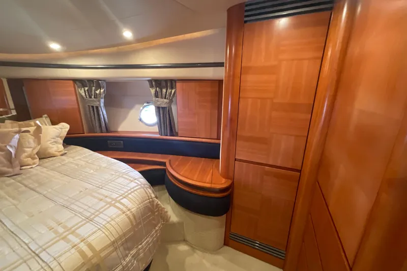  Yacht Photos Pics Luxurious 2005 Azimut Fly 50 yacht cabin with elegant wood paneling and cozy bedding.