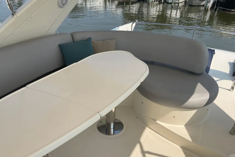  Yacht Photos Pics Luxury seating area on 2005 Azimut Fly 50 yacht with table and cushions.