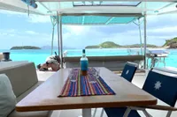 Nautitech 46 Open 2018 catamaran with ocean view, featuring a table and chairs on deck.