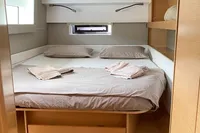 Cozy bedroom in 2018 Nautitech 46 Open catamaran with modern wood furnishings.