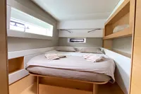 2018 Nautitech 46 Open cabin interior with bed, shelves, and window.